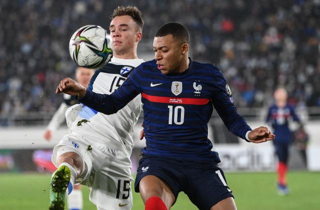 Finland's defender Leo Vaisanen (L) and France's forward Kylian Mbappe vie for the ball during the FIFA World Cup Qatar 2022 qualification Group D football match between Finland and France at the Olympic Stadium in Helsinki, on November 16, 2021. (Photo by FRANCK FIFE / AFP) (Photo by FRANCK FIFE/AFP via Getty Images)