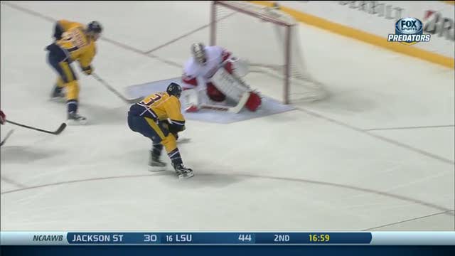 Colin Wilson flips the puck over Jimmy Howard