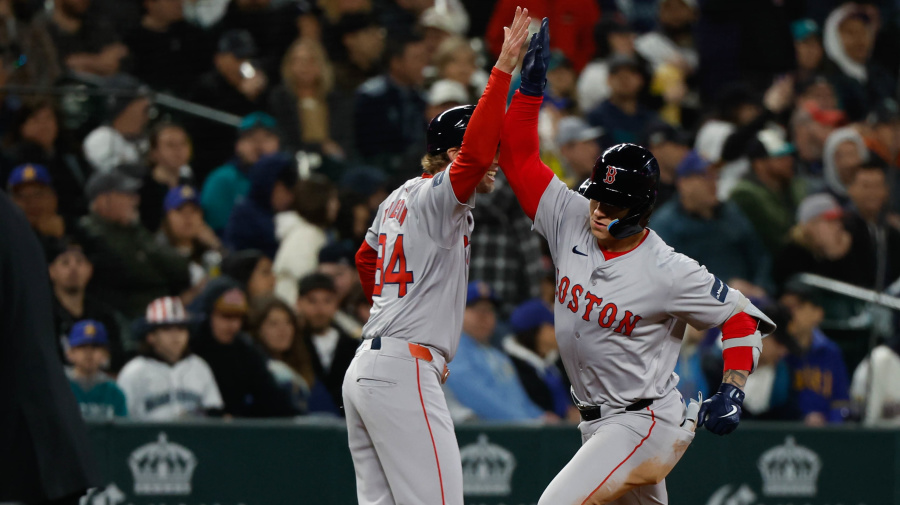 Getty Images - SEATTLE, WA - MARCH 28:   Tyler O'Neill #17 of the Boston Red Sox celebrates with third base coach Kyle Hudson #84 after hitting a solo home run in the eighth inning during the game between the Boston Red Sox and the Seattle Mariners at T-Mobile Park on Thursday, March 28, 2024 in Seattle, Washington. (Photo by Joe Nicholson/MLB Photos via Getty Images)