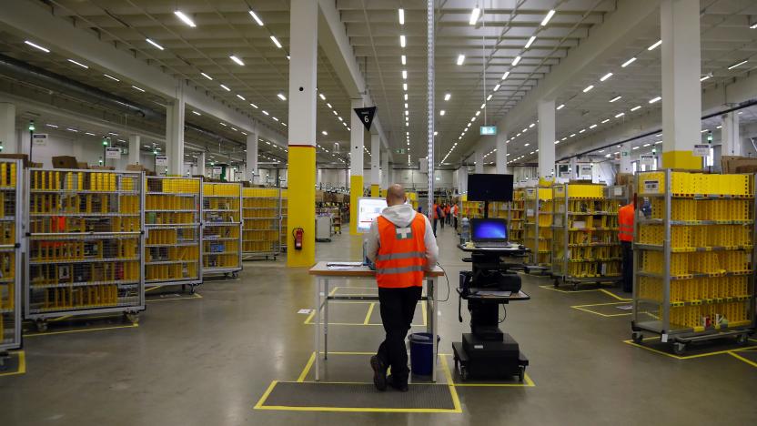 A worker stands his designated workspace at a packing station as he supervises items for delivery from the 70,000 square metre warehouse floor at Amazon's new distribution center in Brieselang, near Berlin November 28, 2013. Germany's antitrust watchdog has dropped an investigation into  Amazon after the world's biggest Internet retailer agreed to stop forcing third-party merchants to offer their cheapest price when selling products on its platform. Andreas Mundt, the president of the German cartel office, said it had decided to set aside the case against Amazon after the company agreed to cancel that demand from the terms and conditions of its contracts with merchants. "Making pricing demands to your own competitors cannot be justified in any circumstances, not even with the undeniable advantages of an online market place."  REUTERS/Tobias Schwarz (GERMANY - Tags: BUSINESS)