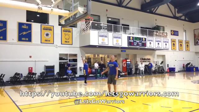 Stephen Curry kicks a basketball into a hoop