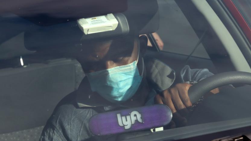 A Lyft rideshare driver wears a mask during the coronavirus outbreak, as he leaves passengers in the U.S. Capitol Hill neighborhood in Washington, U.S. April 1, 2020.  REUTERS/Jonathan Ernst