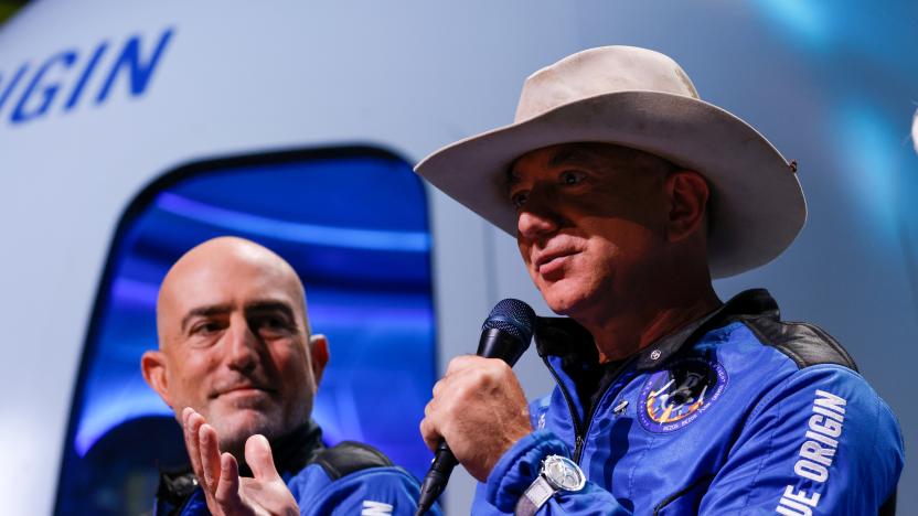 Billionaire American businessman Jeff Bezos speaks with his brother Mark at a post-launch press conference after they flew on Blue Origin's inaugural flight to the edge of space, in the nearby town of Van Horn, Texas, U.S., July 20, 2021.   REUTERS/Joe Skipper