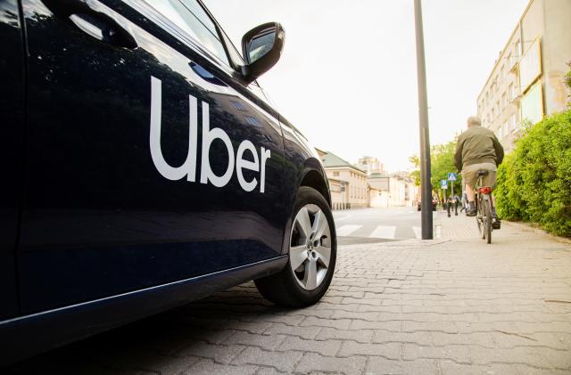 Warsaw, Poland  - April 30, 2019: View on Uber car (Skoda) with inscription on the street before sunset