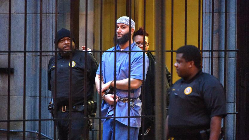 Officials escort "Serial" podcast subject Adnan Syed from the courthouse on Feb. 3, 2016, following the completion of the first day of hearings for a retrial in Baltimore, Md. (Karl Merton Ferron/Baltimore Sun/Tribune News Service via Getty Images)