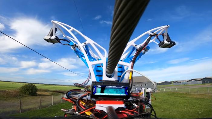 A drone hooked onto a power line.