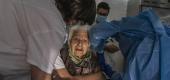 An elderly woman in Barcelona, Spain, gets her second vaccination shot. (José Colon)