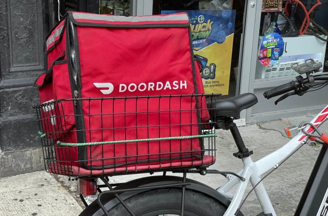 Photo by: STRF/STAR MAX/IPx 2021 10/9/21 DoorDash and other food delivery companies will have to disclose all prices and give workers all tips under new California law. Here, DoorDash delivery bike is seen in Manhattan.