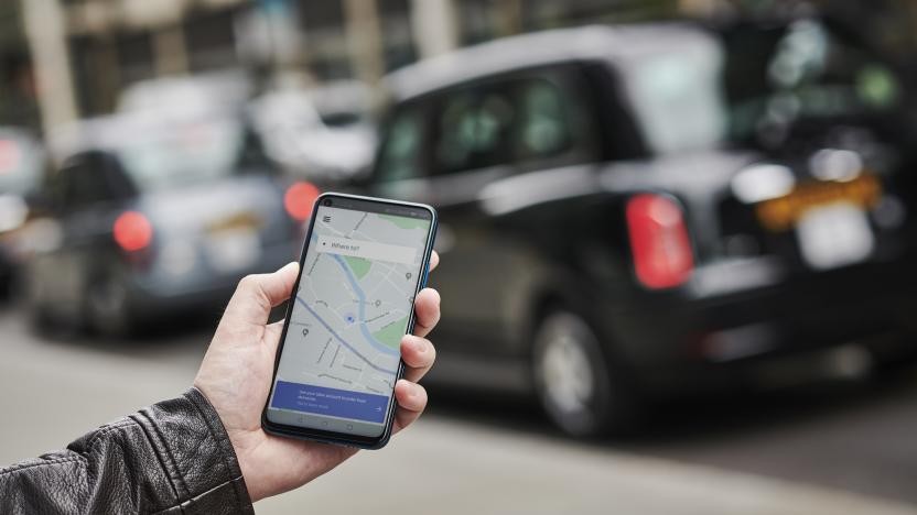 LONDON, UNITED KINGDOM - JUNE 4: Detail of a man holding up an Honor 20 Pro smartphone with the Uber transport app visible on screen, while taxis queue in the background, on June 4, 2019. (Photo by Olly Curtis/Future via Getty Images)