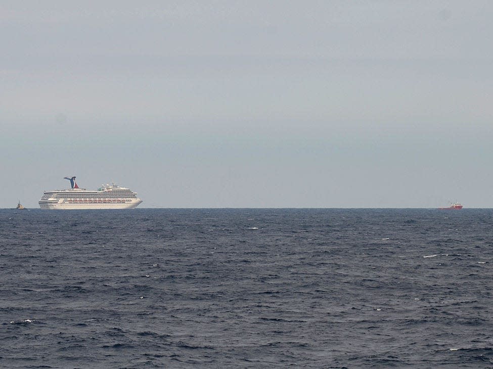 A Carnival cruise passenger that jumped overboard was seen being restrained by s..