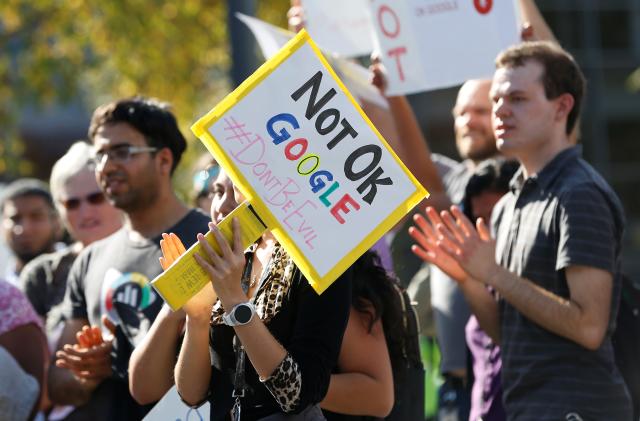 A Google employee holds a sign during a "women's walkout" at their Googleplex offices in protest over the company's handling of a large payout to Android chief Andy Rubin as well as concerns over several other managers who had allegedly engaged in sexual misconduct at the company in Mountain View, California, U.S., November 1, 2018. REUTERS/Stephen Lam