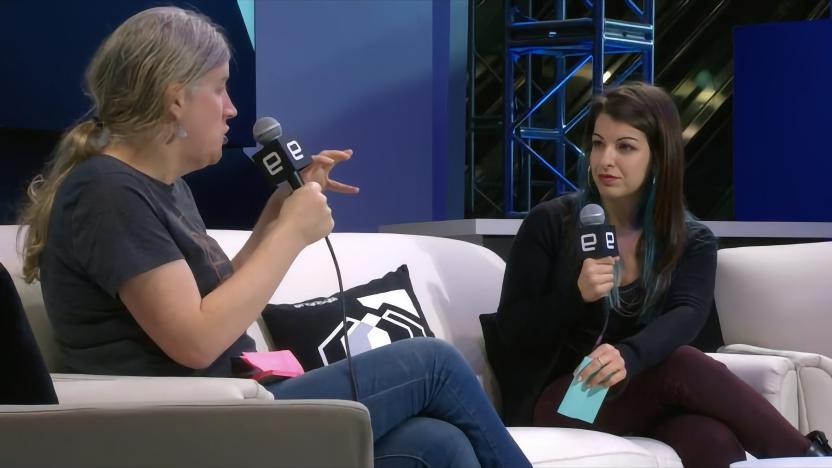 2017 Engadget interview with Feminist Frequency Executive Director Anita Sarkeesian. She sits on a couch on a stage participating in an interview.