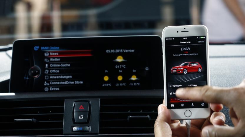 An employee connects a mobile device with the Connected Drive remote-services system of a BMW 116i during the opening of the 85th International Motor Show in Geneva March 5, 2015. REUTERS/Arnd Wiegmann (SWITZERLAND  - Tags: TRANSPORT BUSINESS)  