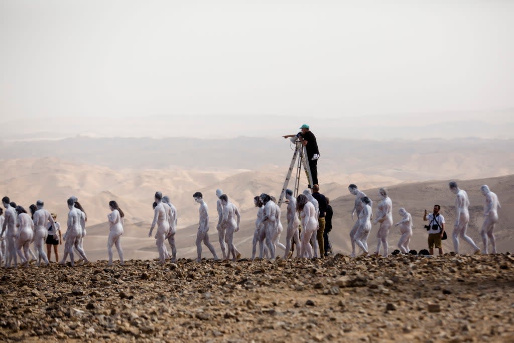 Artist gets hundreds of models to pose naked next to Dead Sea, drawing attention to climate crisis