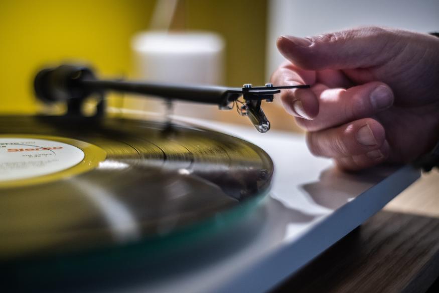 A man playing a turntable vinyl record player  in a  music store in Paris, on February 18, 2020. (Photo by Martin BUREAU / AFP) (Photo by MARTIN BUREAU/AFP via Getty Images)