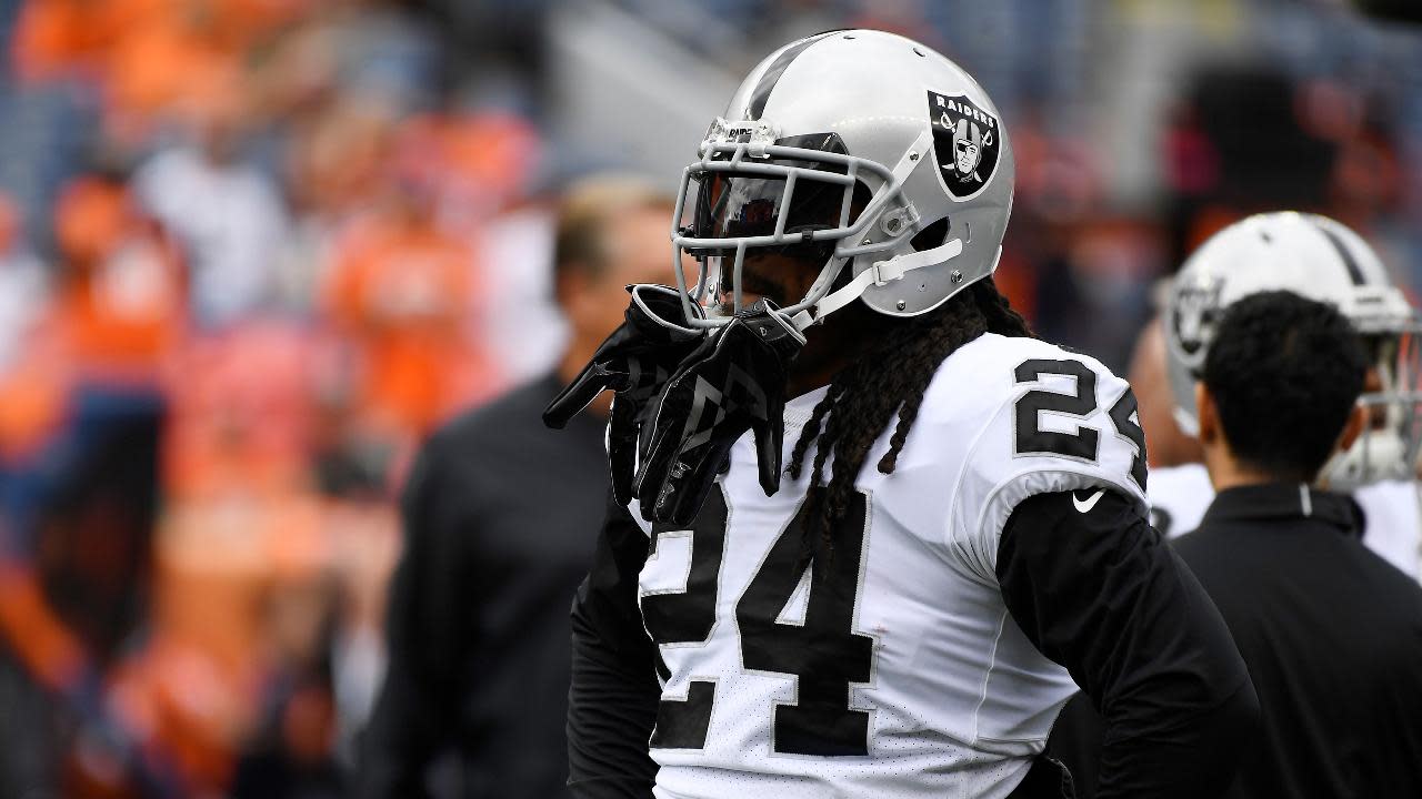 Raiders RB Marshawn Lynch sits during national anthem