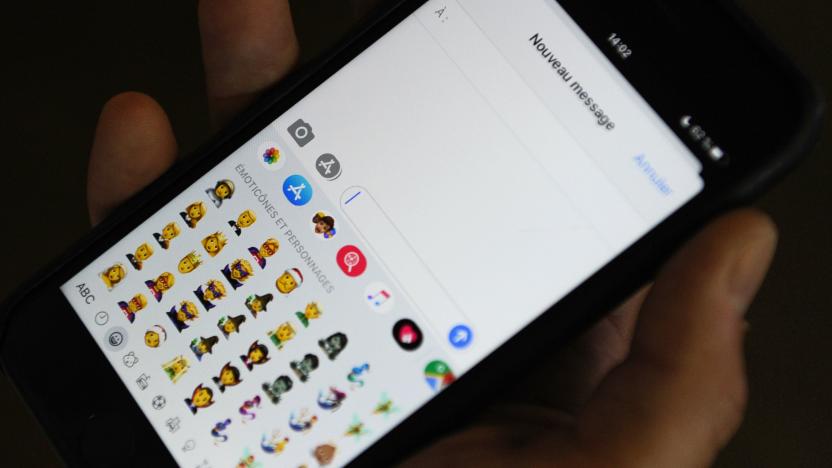 A person holds an iPhone showing emojis in Hong Kong, on October 30, 2019. - Apple has put out new gender neutral emojis of most of its people icons -- including punks, clowns and zombies -- as part of an update to its mobile operating system.
The tech giant has offered growing numbers of inclusive designs in recent years, putting out a range of skin tones and occupations, with Google's Android publishing its own non-binary faces in May. (Photo by TENGKU Bahar / AFP) (Photo by TENGKU BAHAR/AFP via Getty Images)