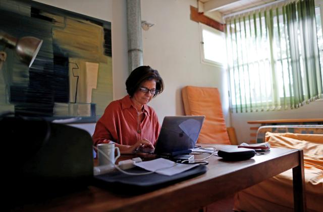 Psychoanalyst Roxana Meygide Schargorodsky works by video call with a patient, at her home in Buenos Aires, Argentina April 7, 2020. Picture taken April 7, 2020. 