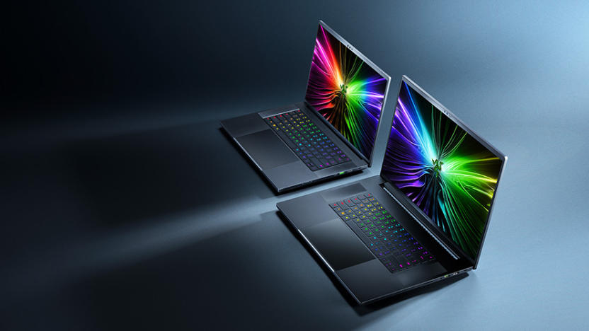Marketing photo for the Razer Blade 16 and 18. The laptops sit next to each other on a blue surface with dramatic shadows. View from above and to their right. The laptops are open with colorful images on their screens.