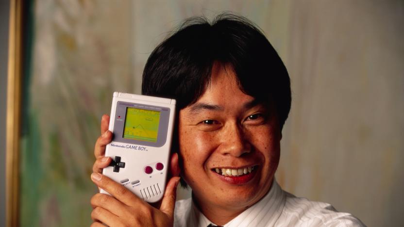 Shigeru Miyamoto, creator of Mario and other characters and video games for Nintendo, holds a Nintendo Game Boy containing the Super Mario World video game. (Photo by © Ralf-Finn Hestoft/CORBIS/Corbis via Getty Images)