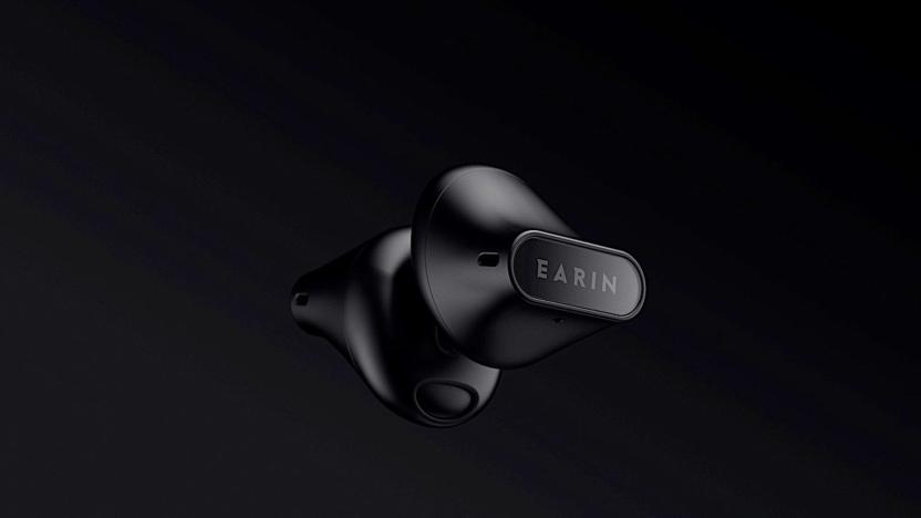 Earin A-3 earbuds in black on a black background.