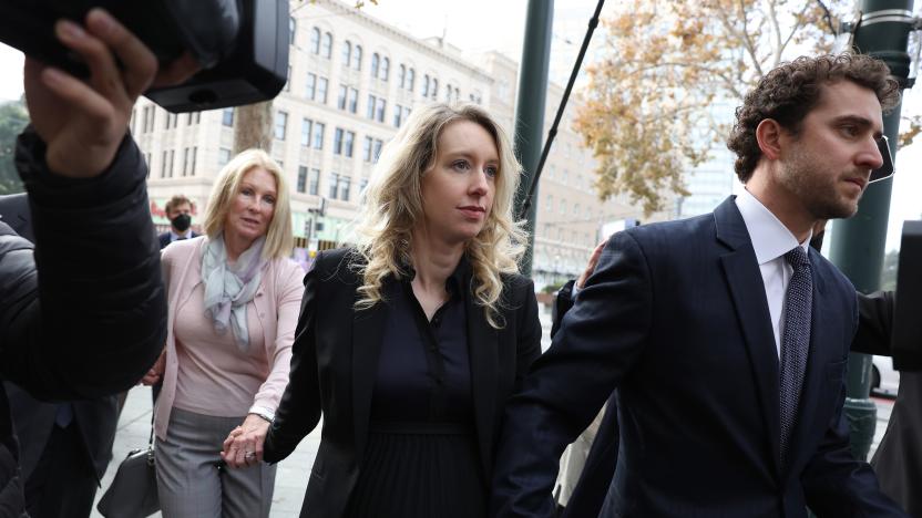 SAN JOSE, CALIFORNIA - NOVEMBER 18: Former Theranos CEO Elizabeth Holmes (C) arrives at federal court with her partner Billy Evans (R) and mother Noel Holmes on November 18, 2022 in San Jose, California. Holmes appeared in federal court for sentencing after being convicted of four counts of fraud for allegedly engaging in a multimillion-dollar scheme to defraud investors in her company Theranos, which offered blood testing lab services. (Photo by Justin Sullivan/Getty Images)