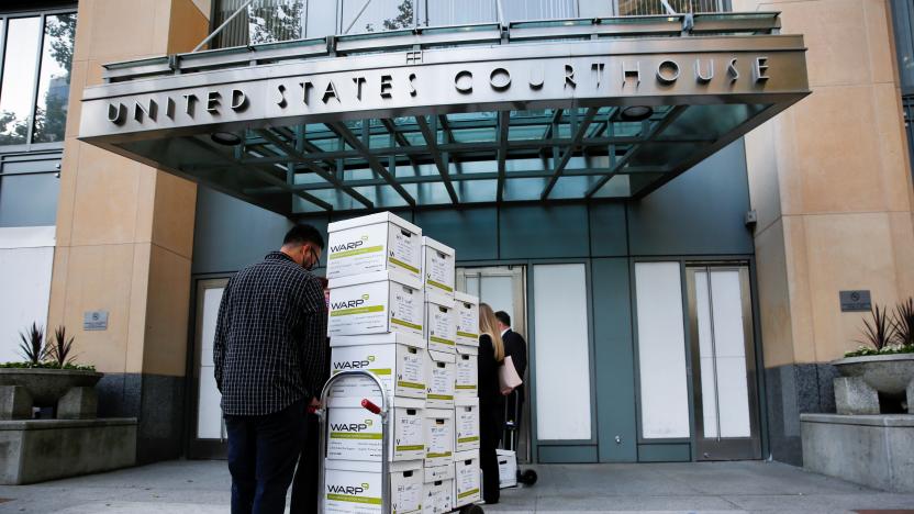 Court documents provided by Gibson, Dunn and Crutcher, LLP, the law firm representing Apple, are brought to the Oakland Federal courthouse for a weeks-long antitrust trial at federal court in Oakland, California, U.S., May 3, 2021.  REUTERS/Brittany Hosea-Small