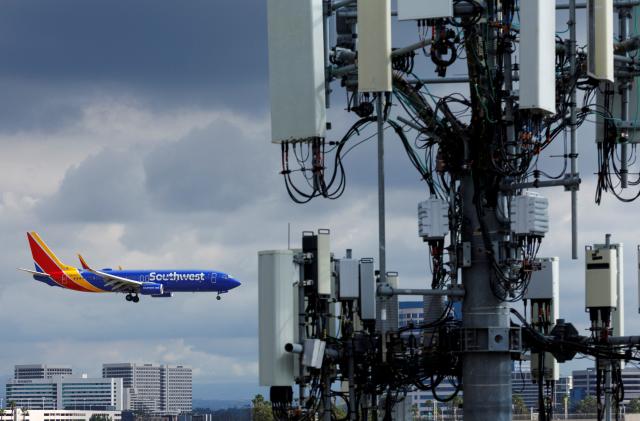 A Southwest commercial aircraft flies near a cell phone tower as it approaches to land at John Wayne Airport in Santa Ana, California U.S. January 18, 2022. U.S. airlines said on Wednesday the rollout of new 5G services was having only a minor impact on air travel as the U.S. Federal Aviation Administration (FAA) said it has issued new approvals to allow more low-visibility landings.    REUTERS/Mike Blake