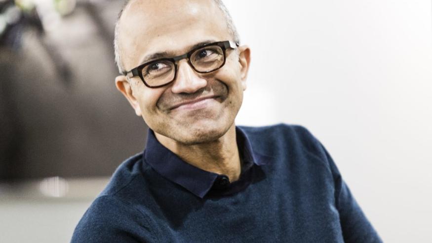 Photo of Microsoft CEO Satya Nadella looking to his right and grinning knowingly.