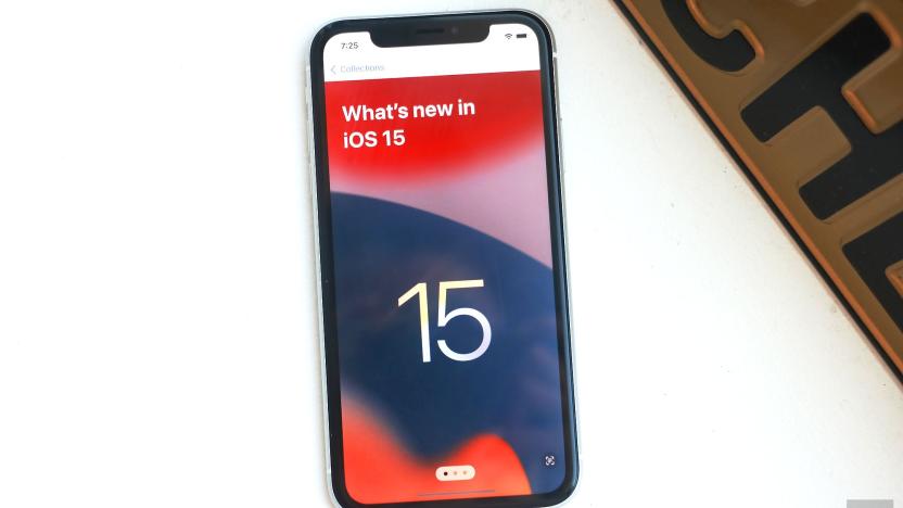 An iPhone XR laying on a white surface showing "What's new in iOS 15" on its screen.