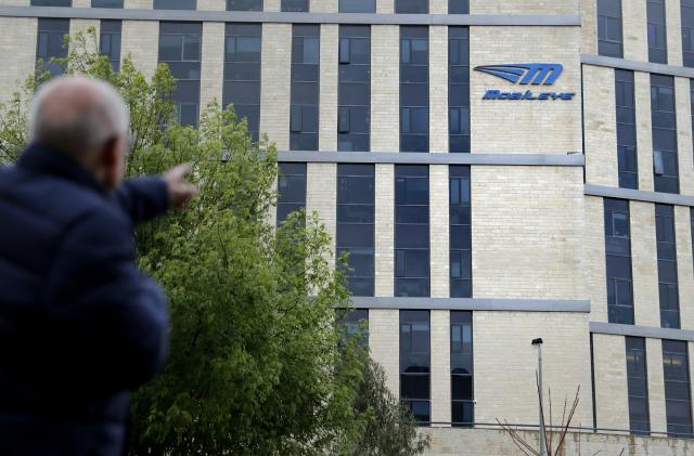 A man walks past the logo of Israeli car tech firm Mobileye on the company's offices in Jerusalem on March 13, 2017.
Intel will buy Mobileye for more than $15 billion (14 billion euros), the companies said, in a deal signalling the US computer chip giant's commitment to technology for self-driving vehicles. / AFP PHOTO / THOMAS COEX        (Photo credit should read THOMAS COEX/AFP via Getty Images)