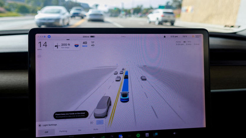 FILE PHOTO: A Tesla Model 3 vehicle warns the driver to keep their hands on the wheel and be prepared to take over at anytime while driving using FSD (Full Self-Driving) in Encinitas, California, U.S., October 18, 2023.     REUTERS/Mike Blake/File Photo