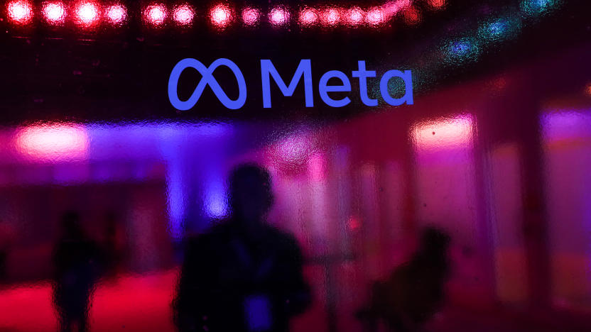 People walk behind a logo of Meta Platforms company, during an event in Mumbai, India, 20 September, 2023 (Photo by Niharika Kulkarni/NurPhoto via Getty Images)