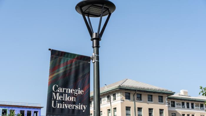 Pittsburgh, Pennsylvania  July 23, 2023: Carnegie Mellon University campus sign with school buildings in background