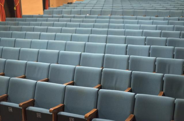 Inside a cinema in Bologna, in the Bolognina district, with seats for the spectators and the empty room