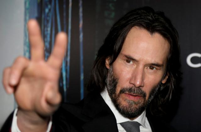 Actor Keanu Reeves gestures during the "Black Carpet" of the Canadian premiere of The Matrix Resurrections film in his former home town of Toronto, Ontario, Canada, December 16, 2021.  REUTERS/Carlos Osorio