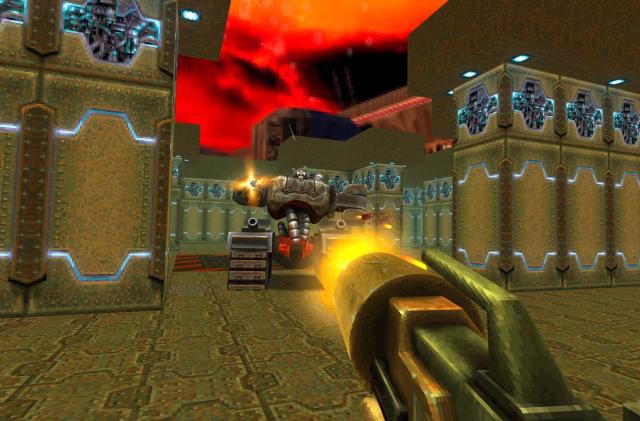 A gun is fired at a robotic enemy from a first-person perspective in Quake II