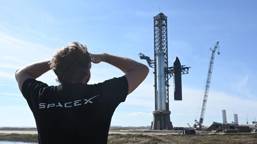 TOPSHOT - A person looks on as SpaceX's huge Super Heavy-Starship is unstacked from the booster as it sits on the launchpad at Starbase in Boca Chica, Texas, on November 16, 2023, ahead of its second test flight posponed to November 18. The US Federal Aviation Administration (FAA) on November 15, 2023 authorized SpaceX to carry out its second launch of Starship, the most powerful rocket ever built, after a first attempt in April ended in a spectacular explosion. (Photo by TIMOTHY A. CLARY / AFP) (Photo by TIMOTHY A. CLARY/AFP via Getty Images)