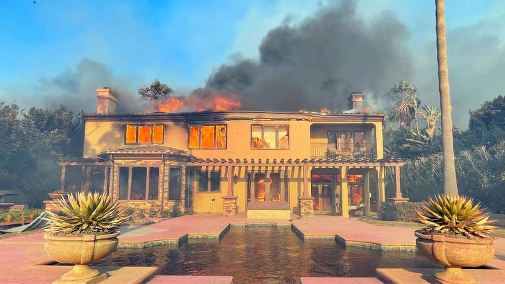 California mansions burn as wildfires spread