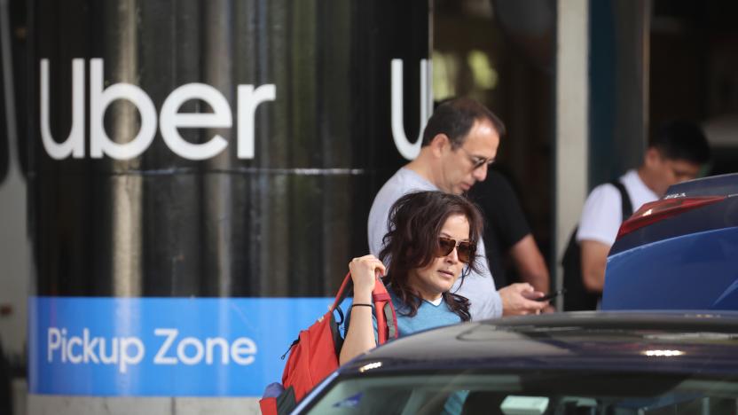 CHICAGO, ILLINOIS - MAY 09: Travelers wait for an Uber ride at Midway International Airport on May 09, 2022 in Chicago, Illinois. Uber plans to cut spending and hiring in an attempt slow the company's plummeting stock price, which is down nearly 50 percent for the year.   (Photo by Scott Olson/Getty Images)