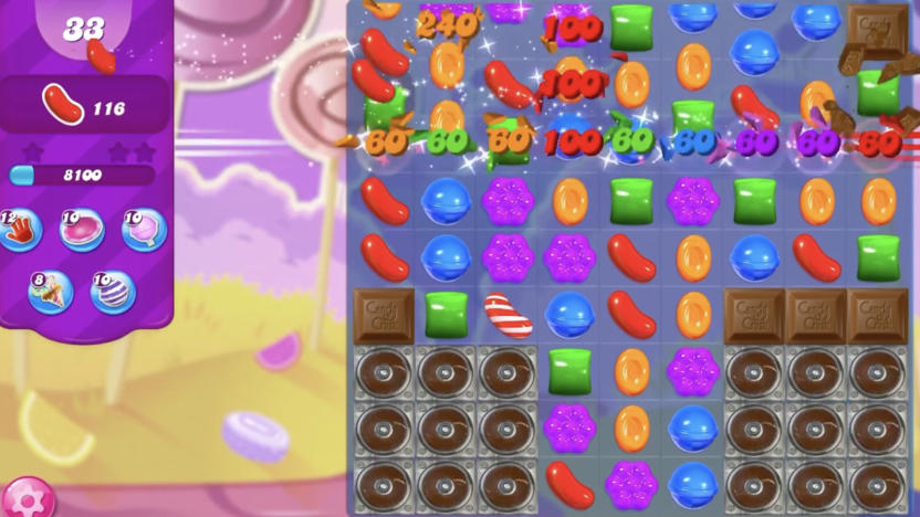 A screenshot of a mobile game showing cartoon candies in a grid.