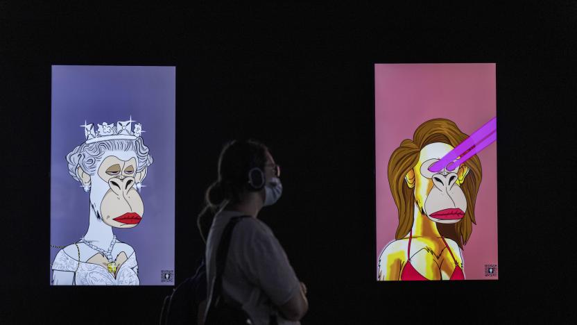 A visitor looks at NFT (non-fungible tokens - blockchain tokens) works featured in Tomorrow, a digital multimedia exhibition at Ramat Gan stadium in Israel, Wednesday, Aug. 24, 2022. The exhibition combines the works of Claude Monet, Wassily Kandinsky, Paul Cézanne, Vincent van Gogh, Gustav Klimt, Aubrey Beardsley among others with digital, multimedia art from the NFT and Virtual Reality realms, closes on Oct. 17. (AP Photo/Tsafrir Abayov)