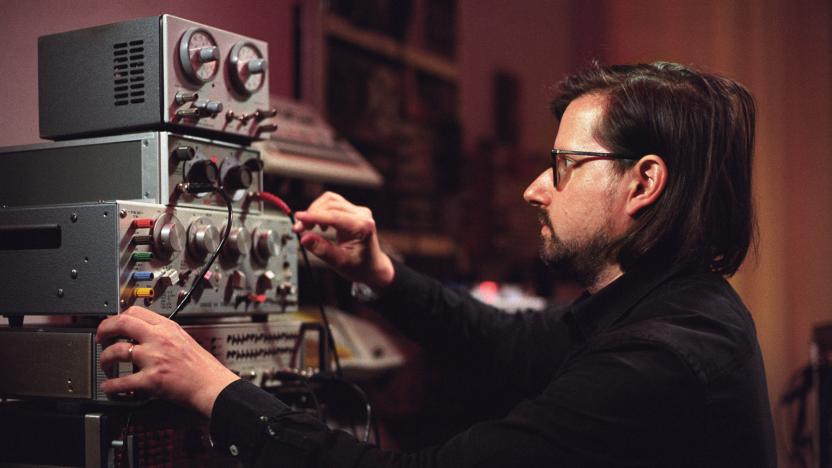 Musician Hainbach playing his test equipment "Landfill Totems"