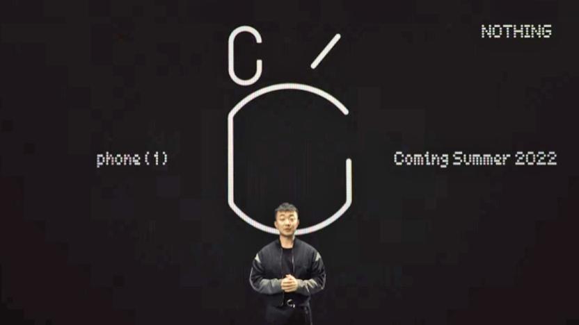 OnePlus founder Carl Pei stands in front of basic black/white text announcing the Nothing Phone (1) coming in summer of 2022.