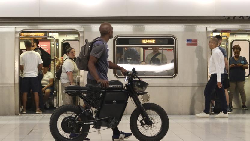 NEW YORK, NY - JULY 17: A man pushes an electric bike along the PATH train platform at the Oculus transit hub at One World Trade Center on July 17, 2023, in New York City.  (Photo by Gary Hershorn/Getty Images)