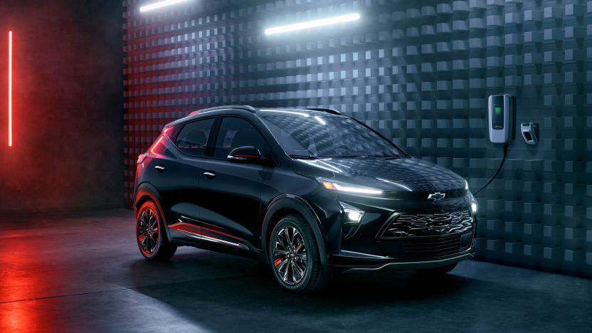 The 2023 Chevy Bolt charging in a modern black space with white and red neon highlights.