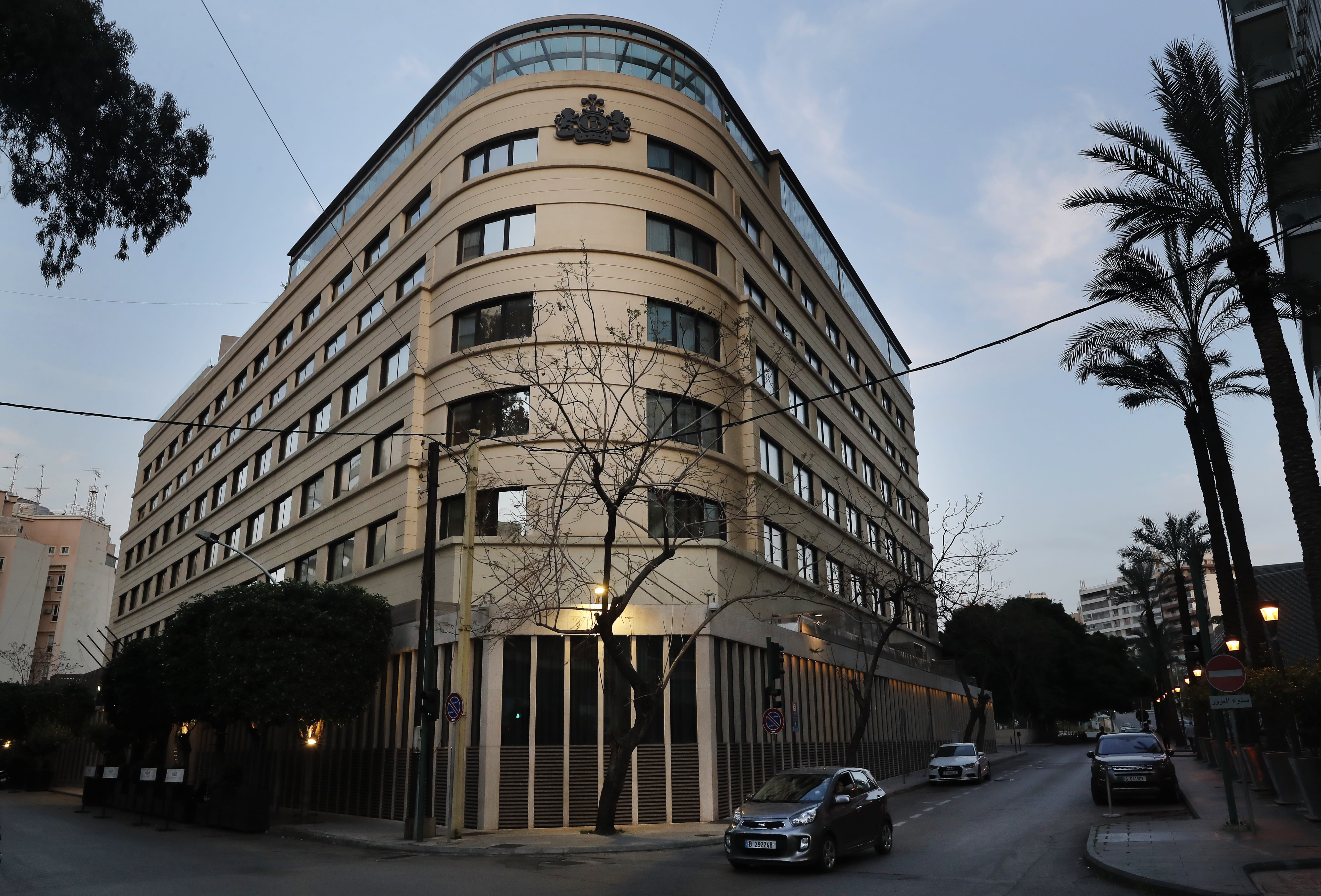 A car drives past Le Bristol hotel in Beirut, Lebanon, Saturday, April 18, 2020. One of the country's landmark hotels that has survived the country's bloody 15-year civil war is closing its doors due to a combination of an economic crisis and the global health threat of the COVID-19 coronavirus, one of its executives said Saturday. (AP Photo/Hussein Malla)