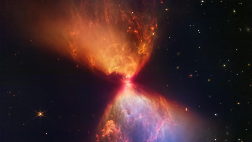 The protostar L1527, shown in this image from the NASA/ESA/CSA James Webb Space Telescope, is embedded within a cloud of material that is feeding its growth. Material ejected from the star has cleared out cavities above and below it, whose boundaries glow orange and blue in this infrared view. The upper central region displays bubble-like shapes due to stellar âburps,â or sporadic ejections. Webb also detects filaments made of molecular hydrogen that has been shocked by past stellar ejections. Intriguingly, the edges of the cavities at upper left and lower right appear straight, while the boundaries at upper right and lower left are curved. The region at lower right appears blue, as thereâs less dust between it and Webb than the orange regions above it.