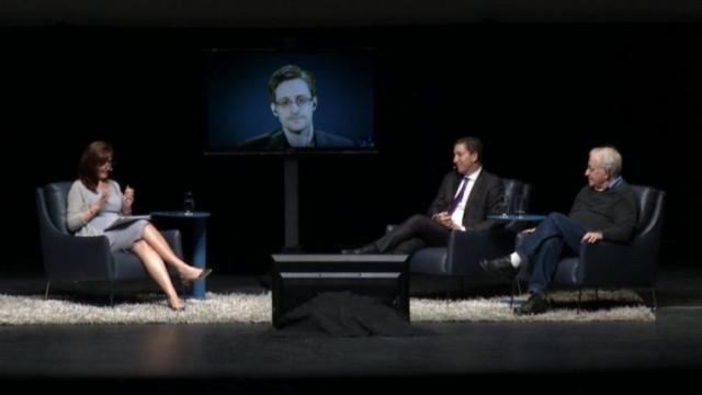 Snowden appearing with Glenn Greenwald and Noam Chomsky at the University of Arizona on March 25, 2016. (Photo via the University of Arizona)