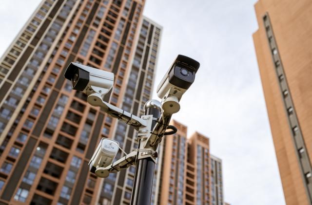 Security camera against residential buildings background